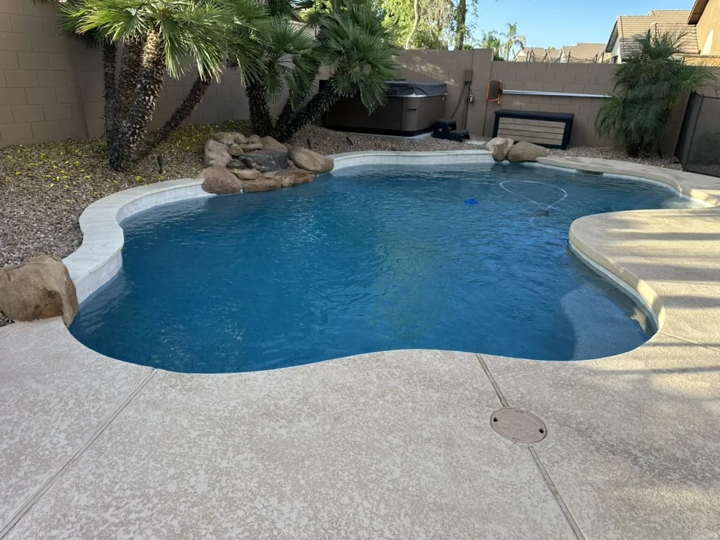 Freeform pool with natural rock water feature
