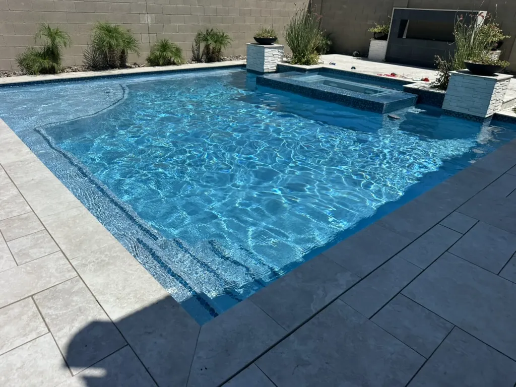 Modern pool with spa and sun shelf