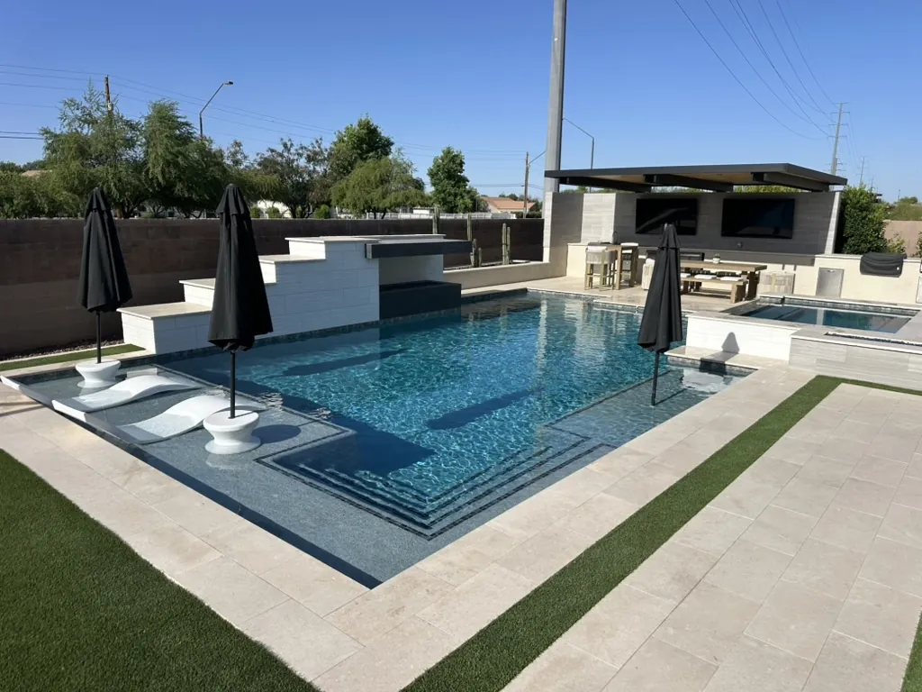 Luxury pool with sun shelf and outdoor kitchen in Gilbert, AZ