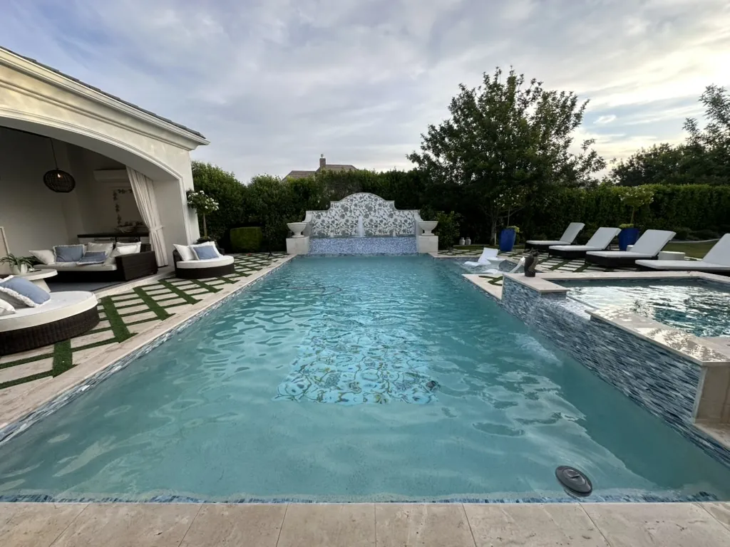 Luxury pool with spa, cabana, and water feature