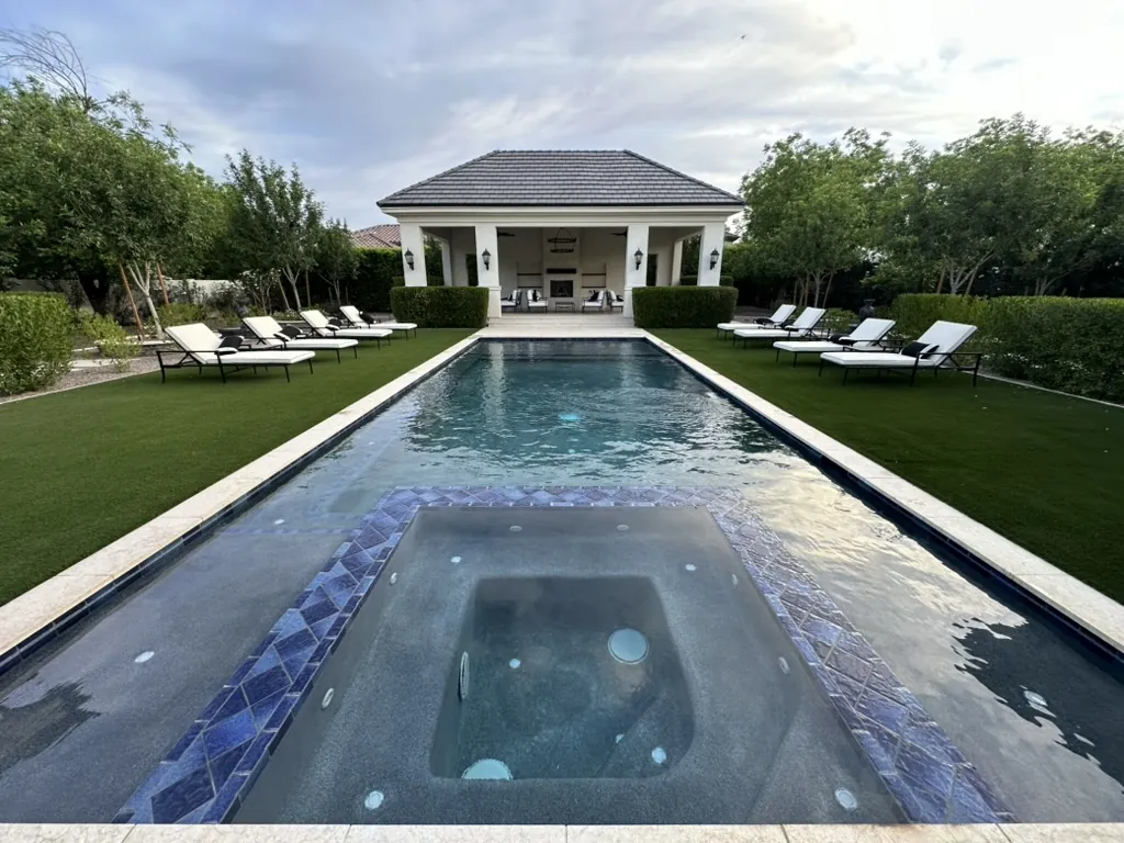 Formal lap pool with spa and pool house