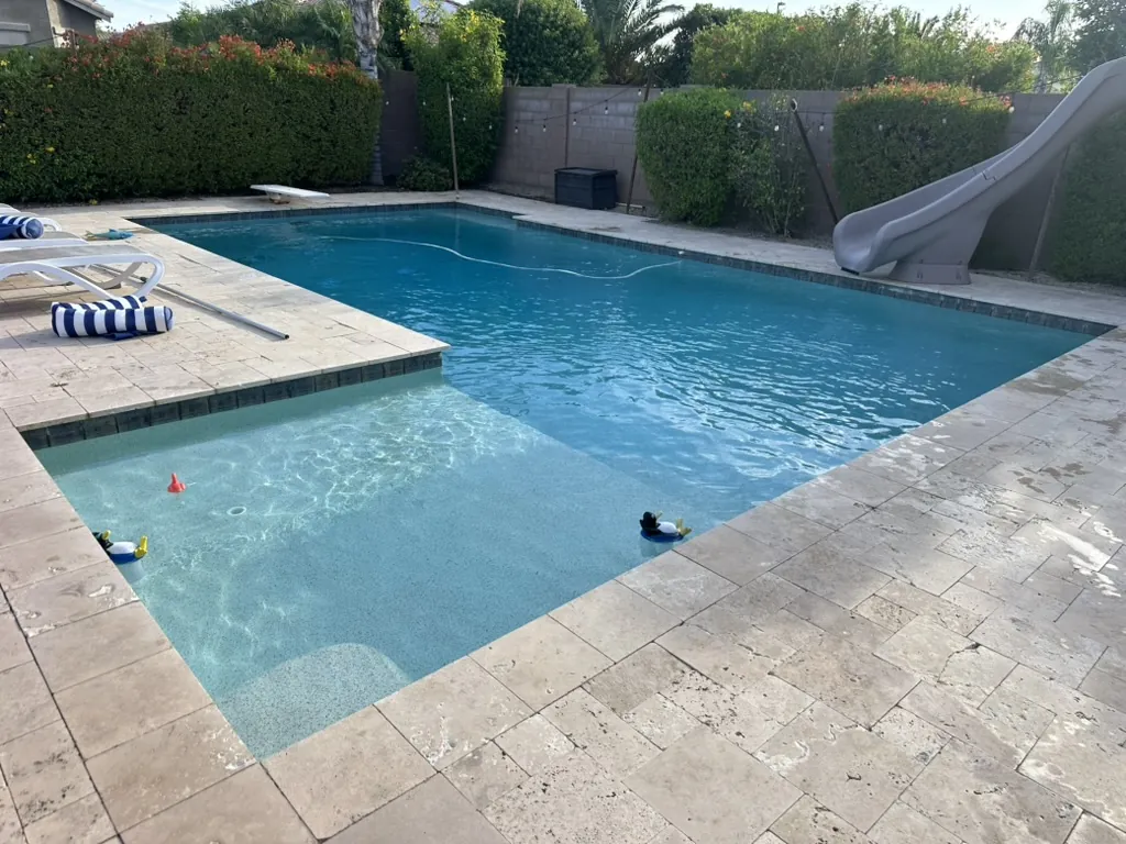 Family pool with slide and Baja shelf in Gilbert, AZ