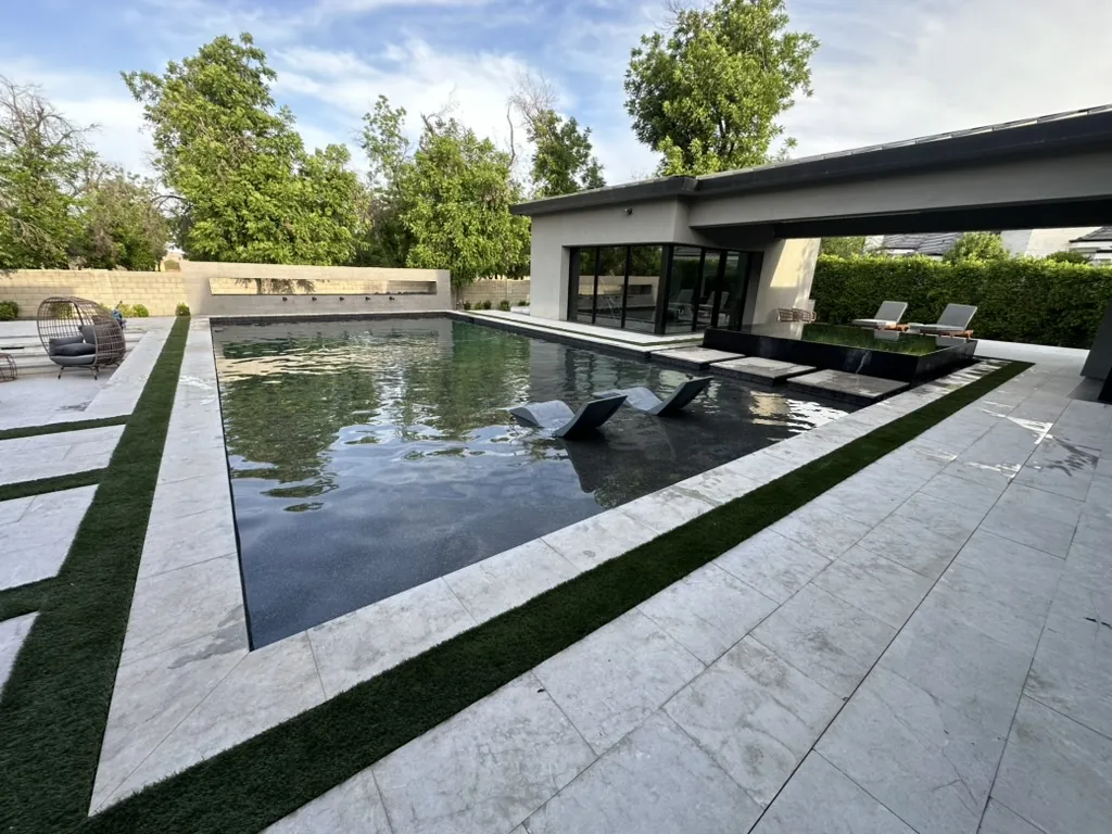Modern dark-bottom pool with sun shelf in Queen Creek, AZ