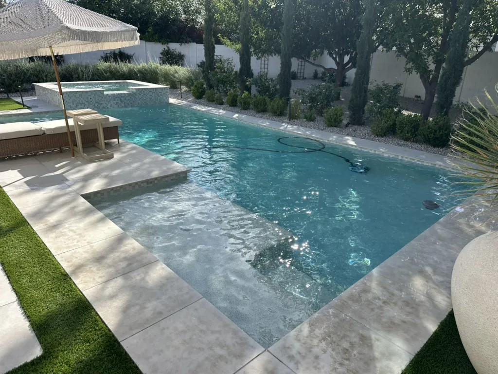 Long pool with spa and tanning shelf
