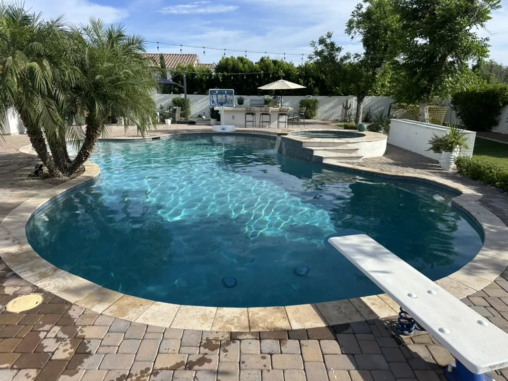 Freeform pool with spa and diving board in Queen Creek, AZ