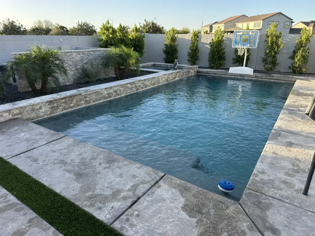 Large geometric pool with spa and basketball hoop