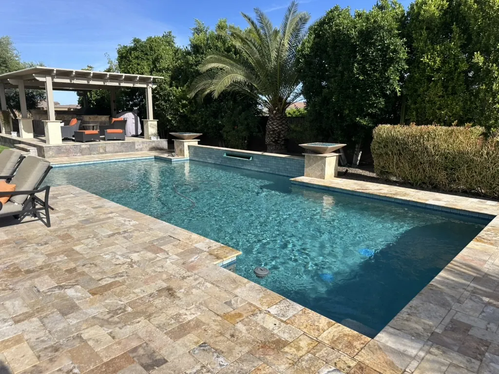 Rectangular pool with pergola and water features